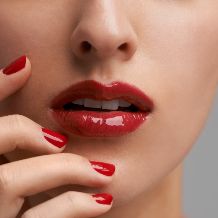 unghia rosse, una manicure a tinta unita con finitura laccata come il rossetto